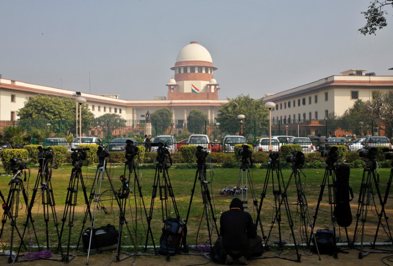 FILE PHOTO: A television journalist sets his camera inside the premises of the Supreme Court in New Delhi