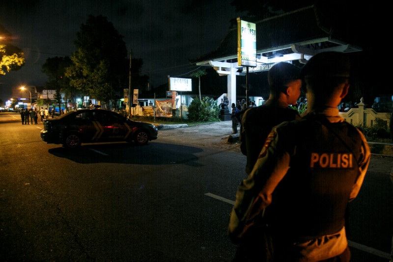 Indonesian police guard is seen near the scene of a shooting in Sleman, Yogyakarta