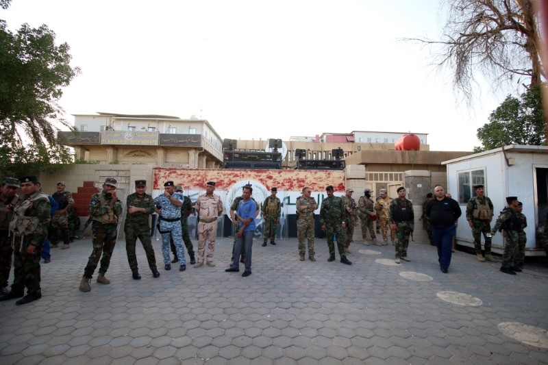 Iraqi security forces stands guard outside the main provincial government building Basra