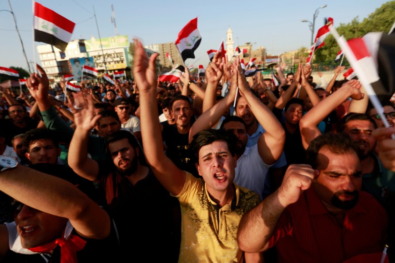 FILE PHOTO: People protest over poor public services in the city of Najaf, Iraq