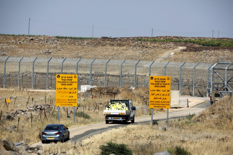 A truck loaded with donations collected in Israeli villages at the Israeli-occupied Golan Heights drives to deliver them over the border to Syria, near the border fence at Israeli-occupied Golan Heights