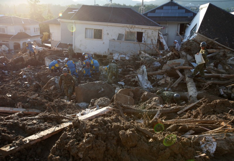 Rescue workers and soldiers search for missing people at a landslide site in Kumano Town