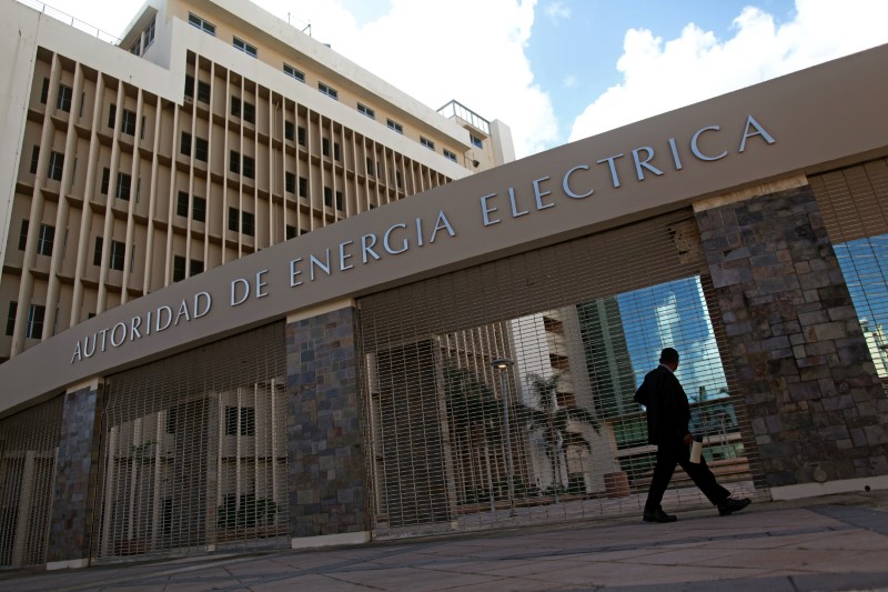 A man walks past the headquarters of the Puerto Rico Electric Power Authority (PREPA) in San Juan