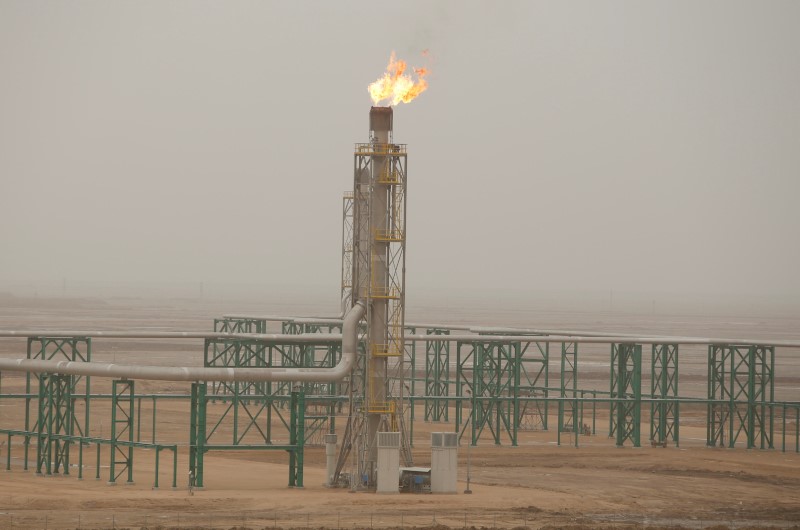 Excess gas is burnt off at a pipeline at the Zubair oilfield in Basra
