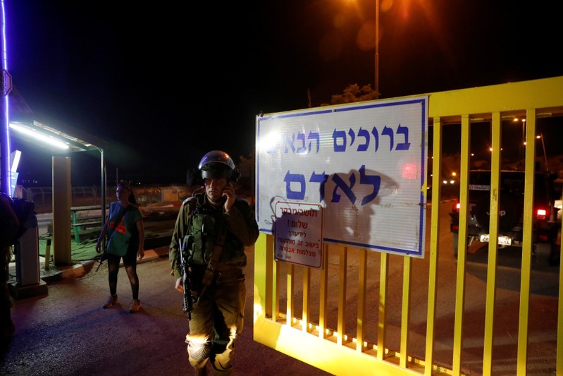A security guard speaks on his mobile phone at the Israeli settlement Adam, after a Palestinian assailant stabbed three people and then was shot and killed, according to the Israeli military, in the occupied West Bank