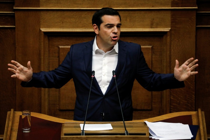 Greek Prime Minister Alexis Tsipras briefs parliament on a debt relief the country reached with its European lenders in Athens