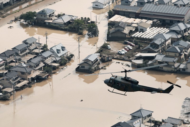 A helicopter flies over Mabi town which was flooded by the heavy rain in Kurashiki