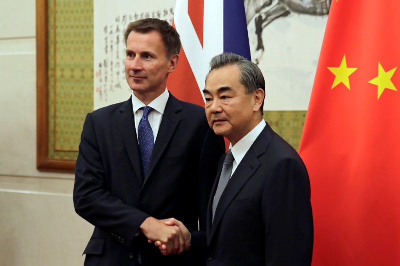 Britain's Foreign Secretary Jeremy Hunt shakes hands with China's Foreign Minister Wang Yi before their meeting at the Diaoyutai State Guesthouse in Beijing