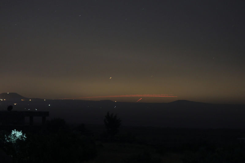 Fire from fighting is seen from Quneitra, Syria