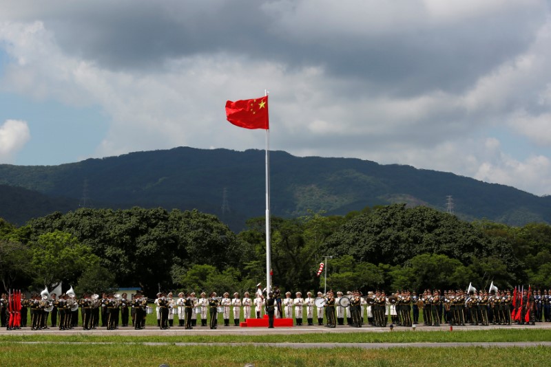 A People's Liberation Army soldiers attend a flag raising ceremony at an airbase in Hong Kong