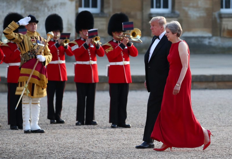 British Prime Minster Theresa May and U.S. President Donald Trump walk across the courtyard at Blenheim Palace near Oxford