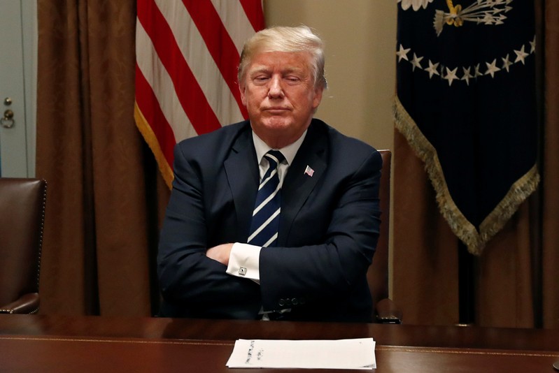 U.S. President Trump waits for reporters to leave the room after speaking about his summit with Russia's President Putin in meeting at the White House in Washington