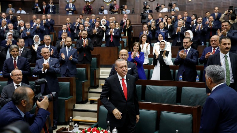 Turkish President Tayyip Erdogan greets members of parliament from his ruling AK Party as he arrives at the Turkish parliament in Ankara