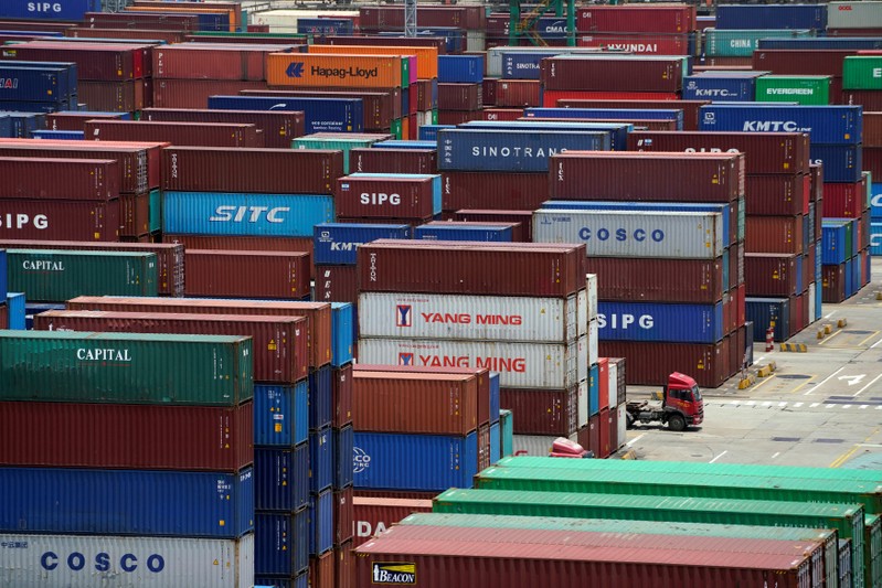 Shipping containers are seen at a port in Shanghai