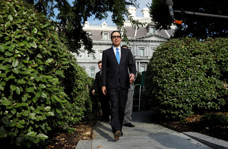 U.S. Treasury Secretary Steve Mnuchin walks toward a group of reporters at the White House in Washington