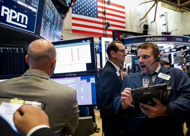 Traders work on the floor of the NYSE in New York