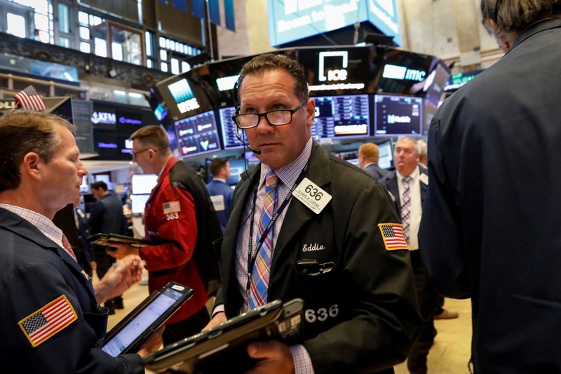 Traders work on the floor of the NYSE in New York