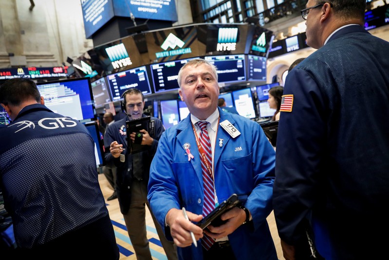 Traders work on the floor of the NYSE in New York