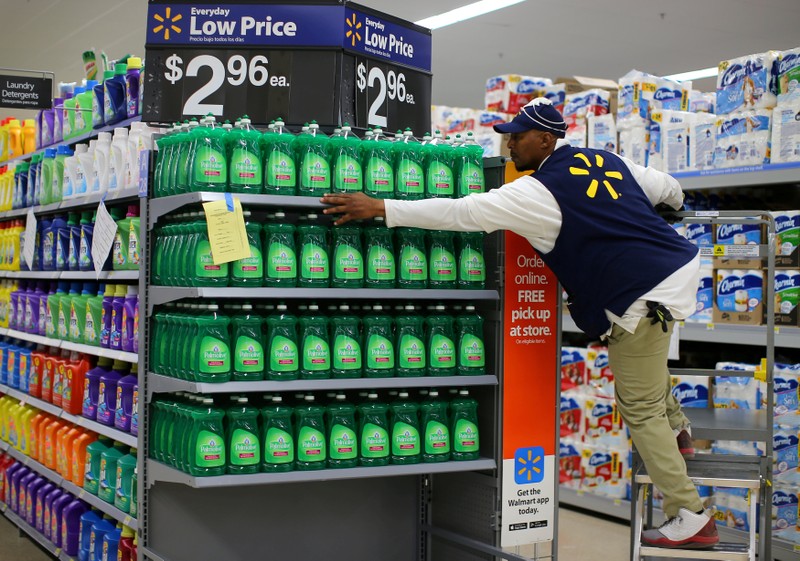 FILE PHOTO: A worker sets up a display of dish washing liquid in prepare for the opening of a Walmart Super Center in Compton, California
