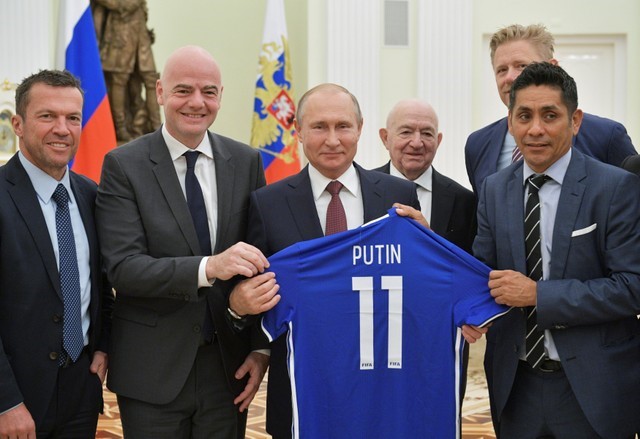 FILE PHOTO: Russia's President Putin attends a meeting with former soccer players and officials in Moscow