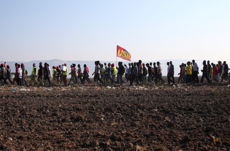 African migrant laborers stage a march to protest against their work conditions in Italy, following the death of 16 of their colleagues in two separate road accidents, near Foggia