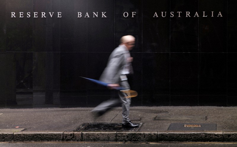 FILE PHOTO: Man walks past the headquarters of Australia's Reserve Bank in Sydney