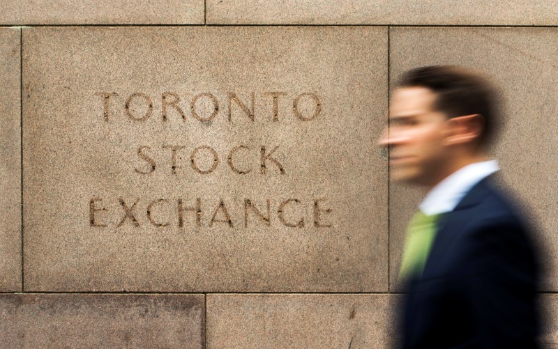 FILE PHOTO - A man walks past an old Toronto Stock Exchange sign in Toronto