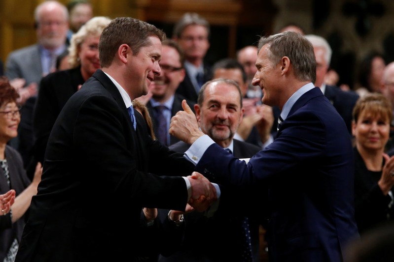 FILE PHOTO - Newly elected Conservative leader Scheer is congratulated by MP Bernier in the House of Commons in Ottawa