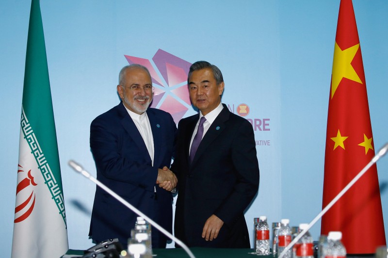 FILE PHOTO - Iran's Foreign Minister Mohammad Javad Zarif and China's Foreign Minister Wang Yi shake hands at a bilateral meeting on the sidelines of the ASEAN Foreign Ministers' Meeting in Singapore