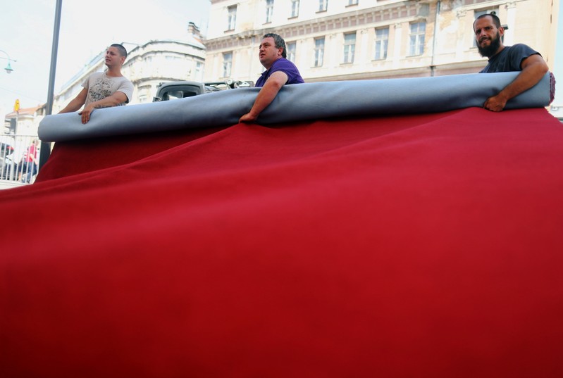 Workers prepare the red carpet for 24th Sarajevo Film Festival in Sarajevo