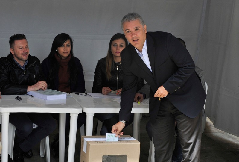 Colombia's President Ivan Duque votes in a seven-question referendum on anti-corruption measures in Bogota
