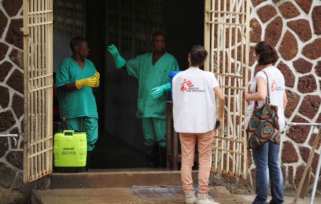 Medecins Sans Frontieres workers talk to a worker at an isolation facility prepared to receive suspected Ebola cases, at the Mbandaka General Hospital, in Mbandaka