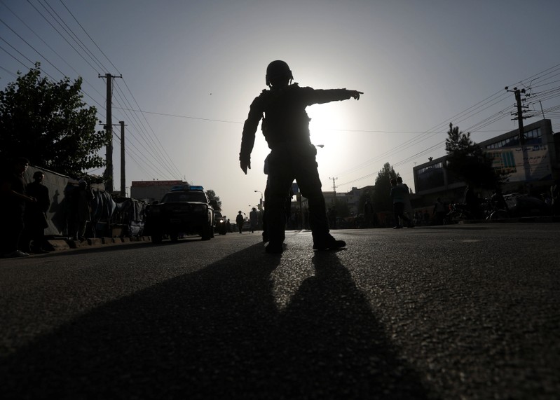 Afghan policemen arrive at the site of a suicide bomb attack in Kabul