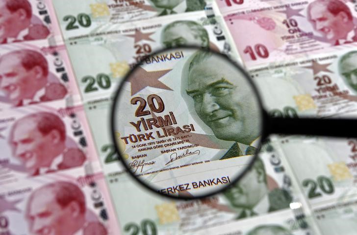 A 20 lira banknote is seen through a magnifying lens in this illustration picture taken in Istanbul