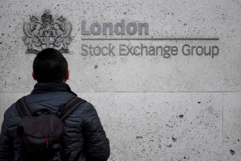 FILE PHOTO: People walk past the London Stock Exchange Group offices in the City of London, Britain