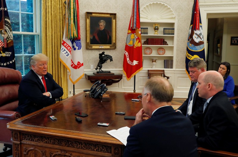 U.S. President Trump answers question during interview with Reuters reporters in Oval Office of White House in Washington