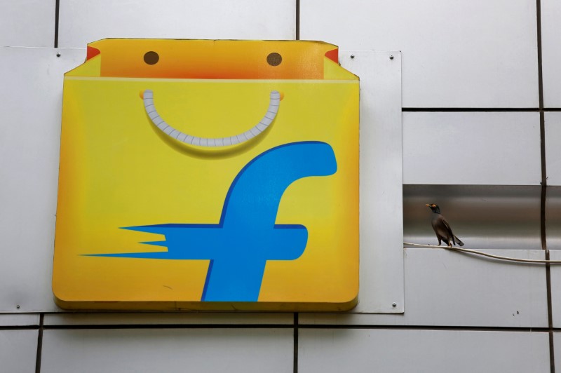 FILE PHOTO: A Common myna sits next to the logo of India's e-commerce firm Flipkart installed on the company's office in Bengaluru