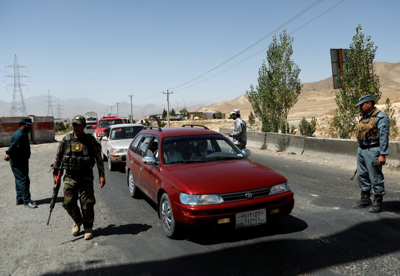 Afghan security forces keep watch at a checkpoint on the Ghazni highway, in Maidan Shar, the capital of Wardak province, Afghanistan