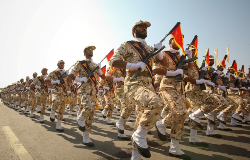 FILE PHOTO: Members of the Iranian revolutionary guard march during a parade to commemorate the anniversary of the Iran-Iraq war (1980-88), in Tehran