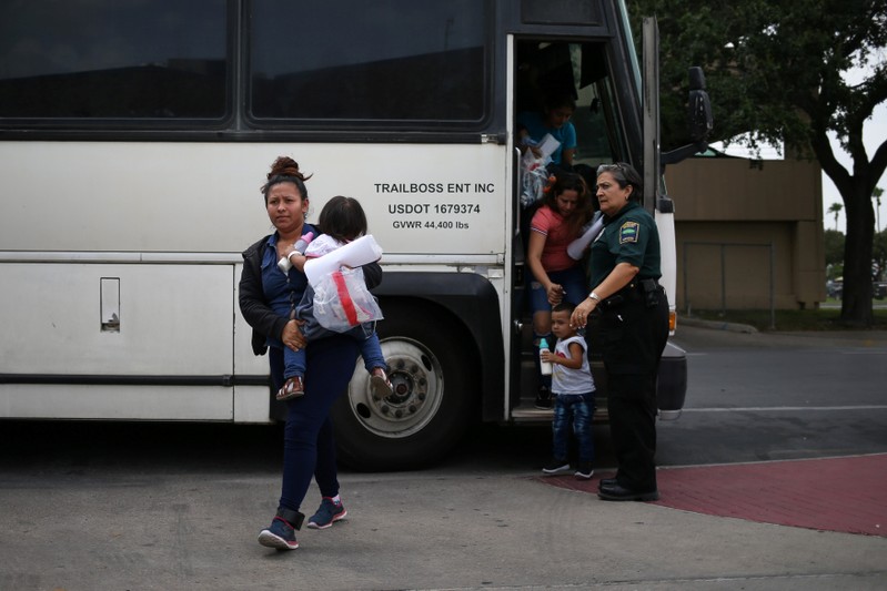 Undocumented immigrant families are released from detention at a bus depot in McAllen