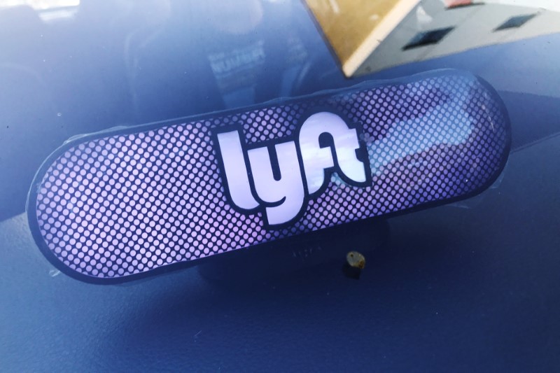 An illuminated sign appears in a Lyft ride-hailing car in Los Angeles