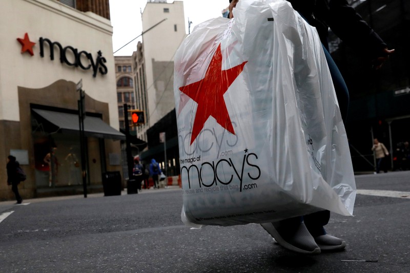 FILE PHOTO: A customer exits after shopping at a Macy's store in the Brooklyn borough of New York