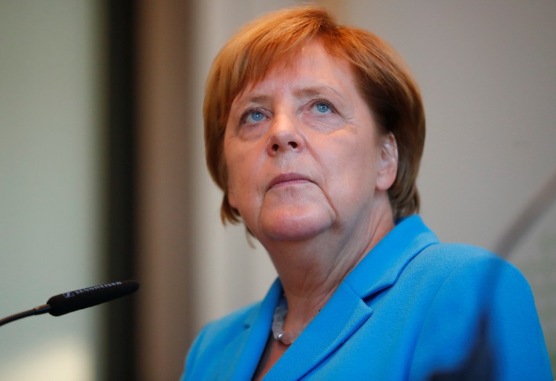 German Chancellor Angela Merkel looks on during a news conference after visiting the state parliament in Dresden