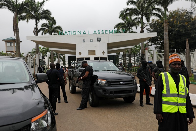 Members of security forces stand at the entrance of the National Assembly in Abuja