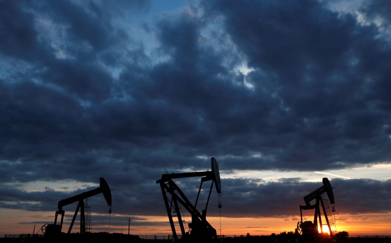 Oil pumps are seen at sunset outside Vaudoy-en-Brie