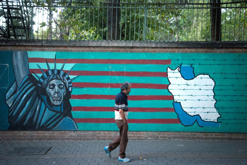 FILE PHOTO: Man walks past anti-U.S. mural in Tehran
