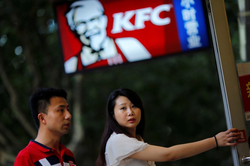 FILE PHOTO: Customers walk into a KFC store in downtown Shanghai