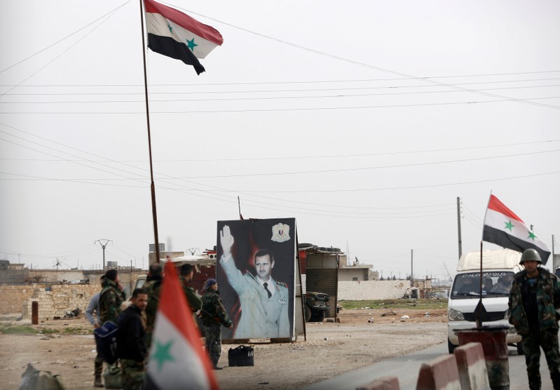 FILE PHOTO: Syrian forces loyal to President Bashar al-Assad hold a checkpoint in Aleppo