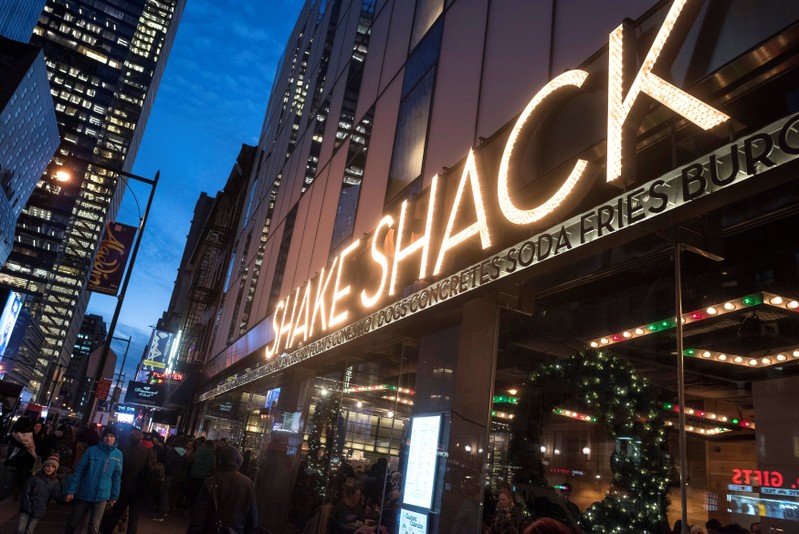 FILE PHOTO: Passersby walk in front of the Shake Shack restaurant in the Manhattan borough of New York