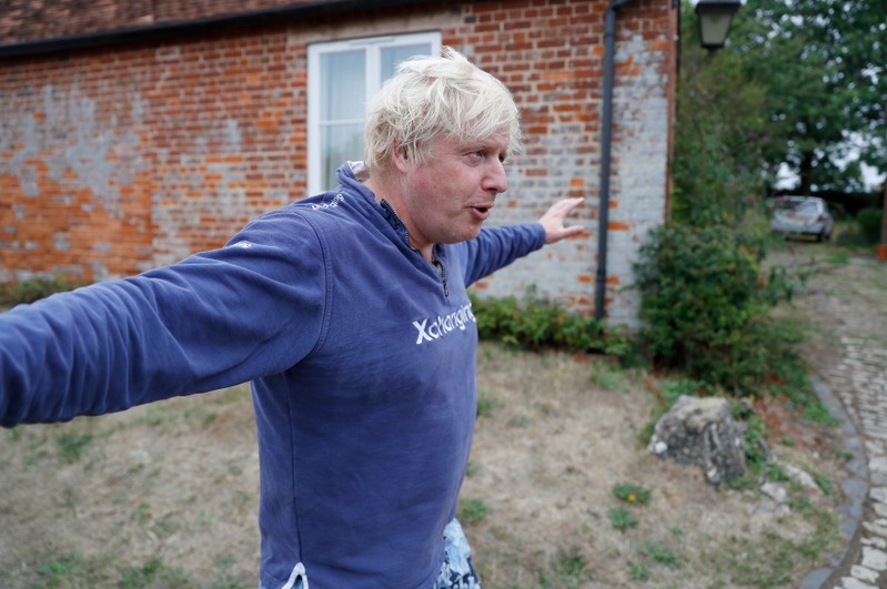 Britain's former Foreign Secretary Boris Johnson stands outside his home near Thame in Oxfordshire